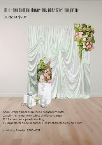 Full event setup showing a sage backdrop, floral pedestals, and candle floor decor for a party.