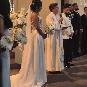 Bride standing during the wedding ceremony while listening attentively