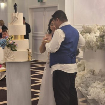 Couple cutting their wedding cake together during reception.