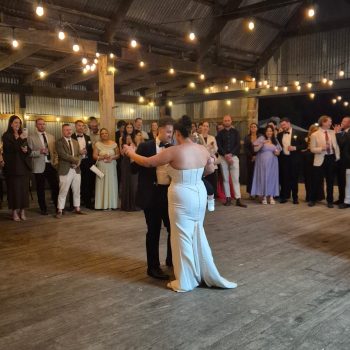 Bride and groom dancing romantically indoors