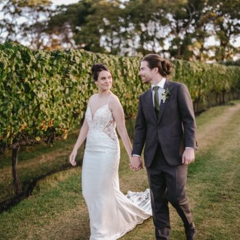 Bride and groom walking tree-lined path at Montalto Winery wedding, coordinated by ARLAI Event Co Melbourne