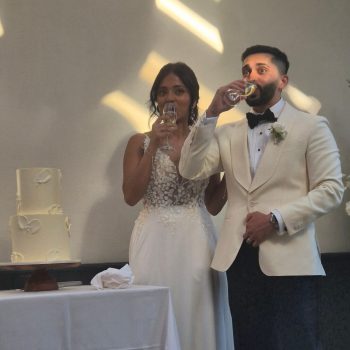 Wedding couple raising glasses for a celebratory toast
