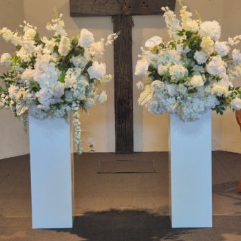 Church interior decorated with white floral arrangements for a wedding