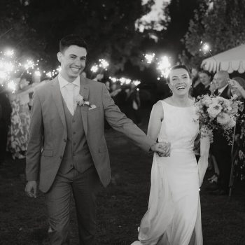 Newlywed couple laughing and sharing a candid, joyful moment together on their wedding day.