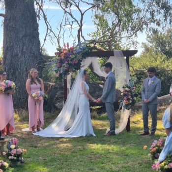 Couple standing at the altar exchanging vows during their wedding ceremony.