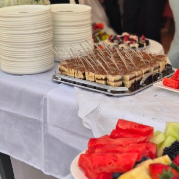 Dessert spread with cakes, berries, and pastries.