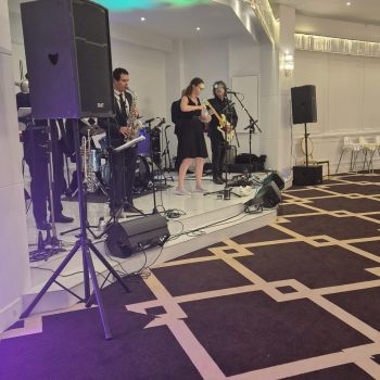 DJ performing live at the wedding reception with equipment setup.