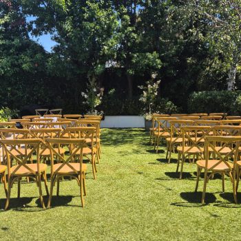 Wedding ceremony seating arrangement with decorated chairs and aisle