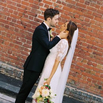 Romantic wedding couple photo capturing a tender and candid moment between two partners
