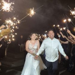 Romantic wedding portrait of the couple posing together outdoors.
