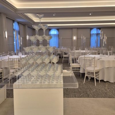 Six-tier champagne tower glass display at a wedding reception