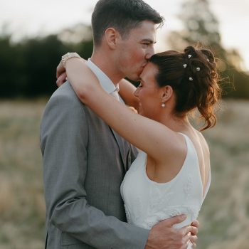 Elegant professional wedding portrait of the bride and groom posing together.