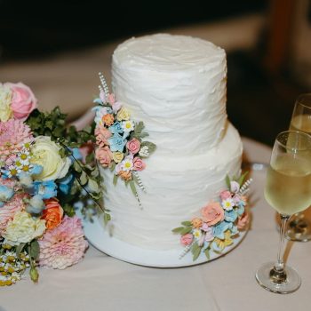 A stunning two-tier wedding cake elegantly decorated on a display table.