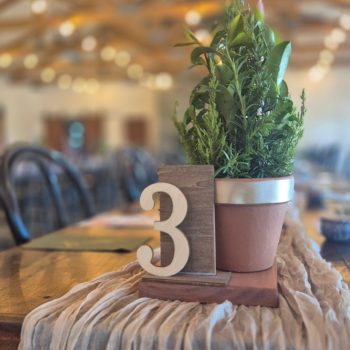 Elegant wedding table number displayed with décor.