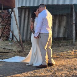Bride and groom smiling together outdoors, capturing a joyful wedding moment