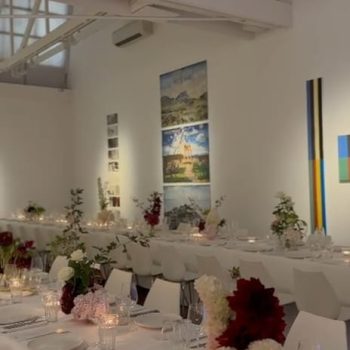 Wide venue overview showcasing event setup with décor, lighting, and guest seating.