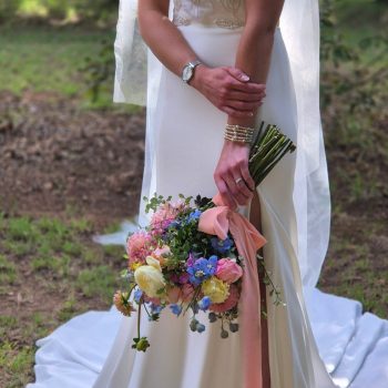 Closeup of bride holding an elegant wedding bouquet with soft florals.