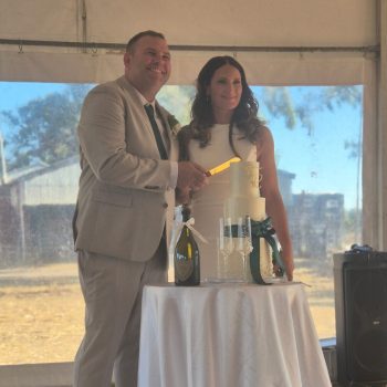 Bride and groom cutting their wedding cake during the celebration