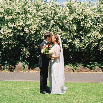 Wedding couple sharing a romantic kiss captured in a portrait