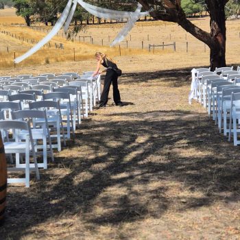 Guests seated outdoors in front of a wedding altar with elegant décor