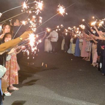 Guests holding sparklers while celebrating during the event.