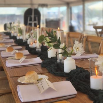 Wedding lunch tables fully set with elegant tableware and floral arrangements