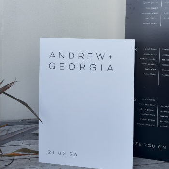 Styled wedding signage at the venue entrance.