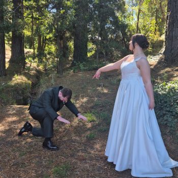 Couple sharing a joyful candid moment during their wedding celebration.