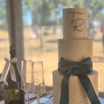 Classic three-tier white wedding cake with elegant decorations